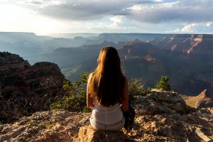 Girl sitting near a canyon